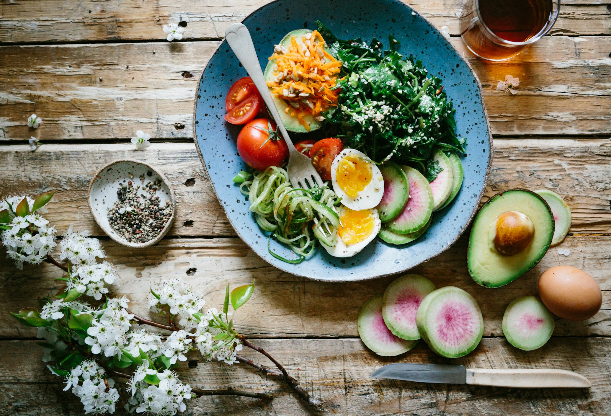A balanced meal featuring a grilled chicken breast, leafy greens, and whole grains.