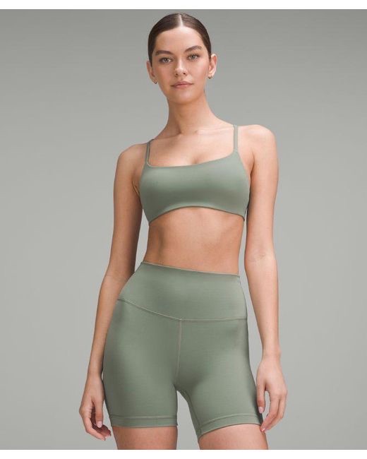 A khaki-toned strappy racerback sports bra from Lululemon.