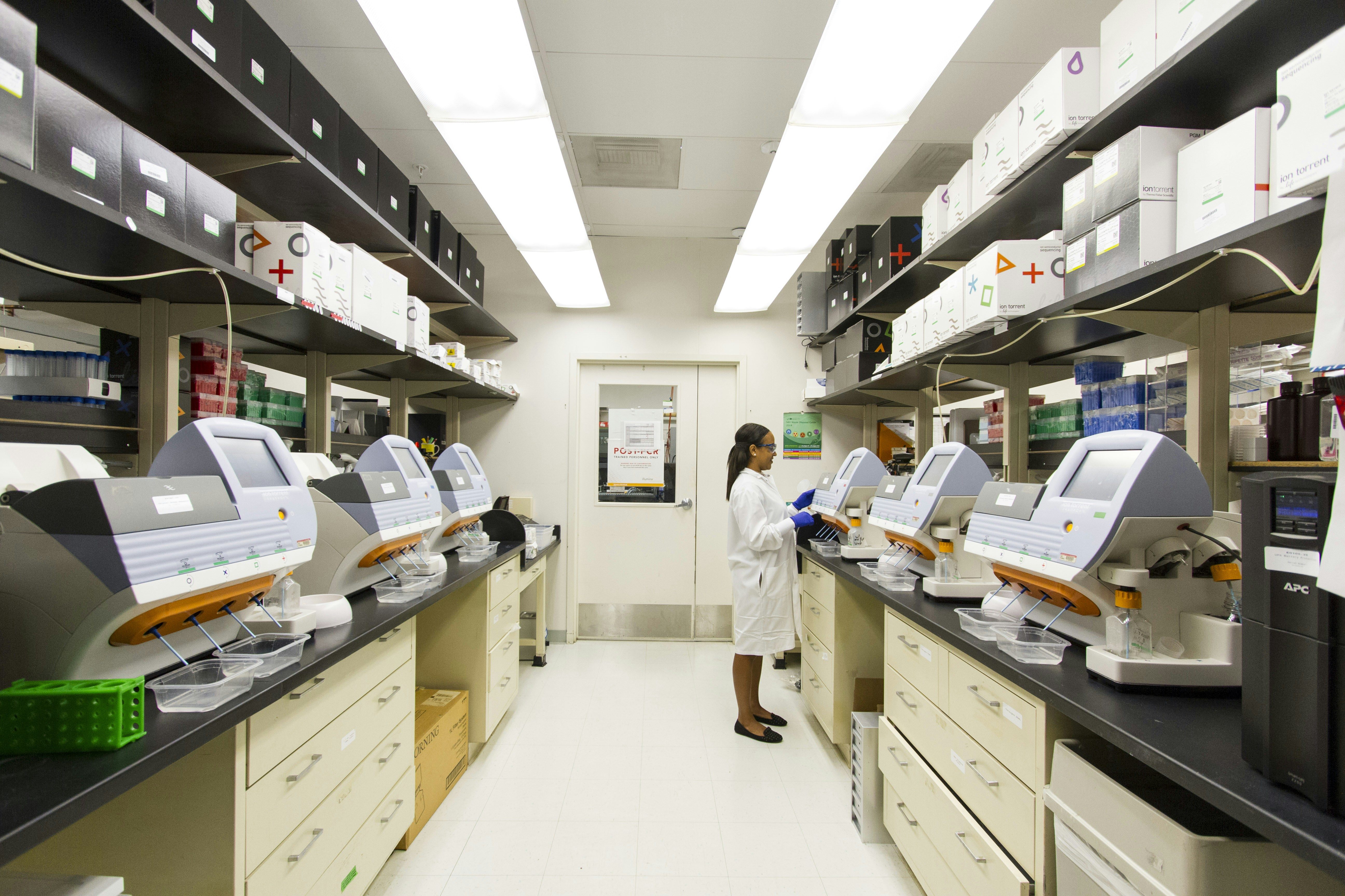 A medical professional in a lab setting preparing a blood sample for a lipid profile test.