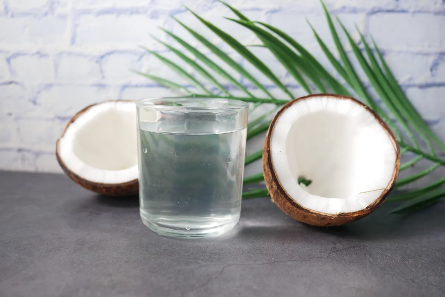 A refreshing glass of clear coconut water.