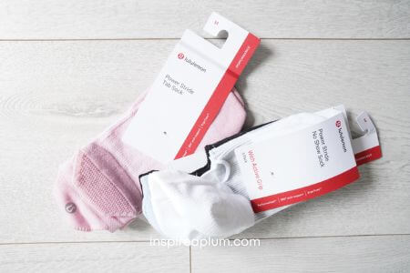 A side-by-side comparison of different Lululemon sock styles worn on feet.