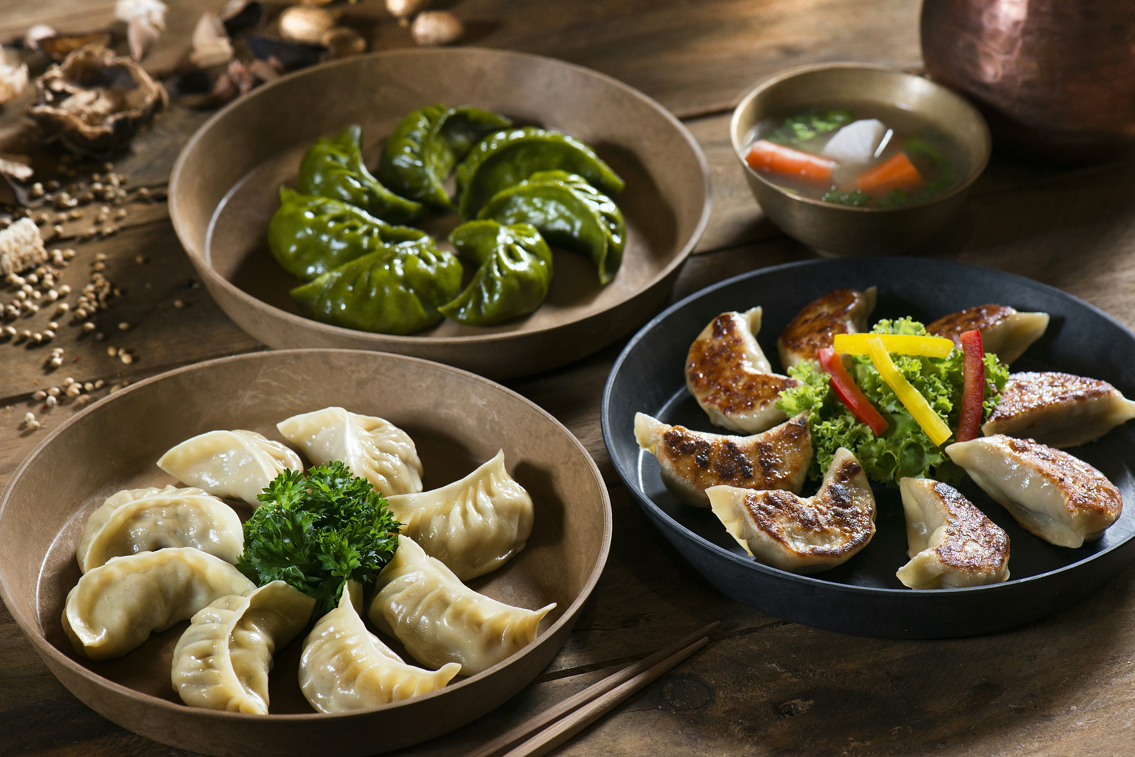 An overhead view of various spicy and fried dishes laid out on a table.