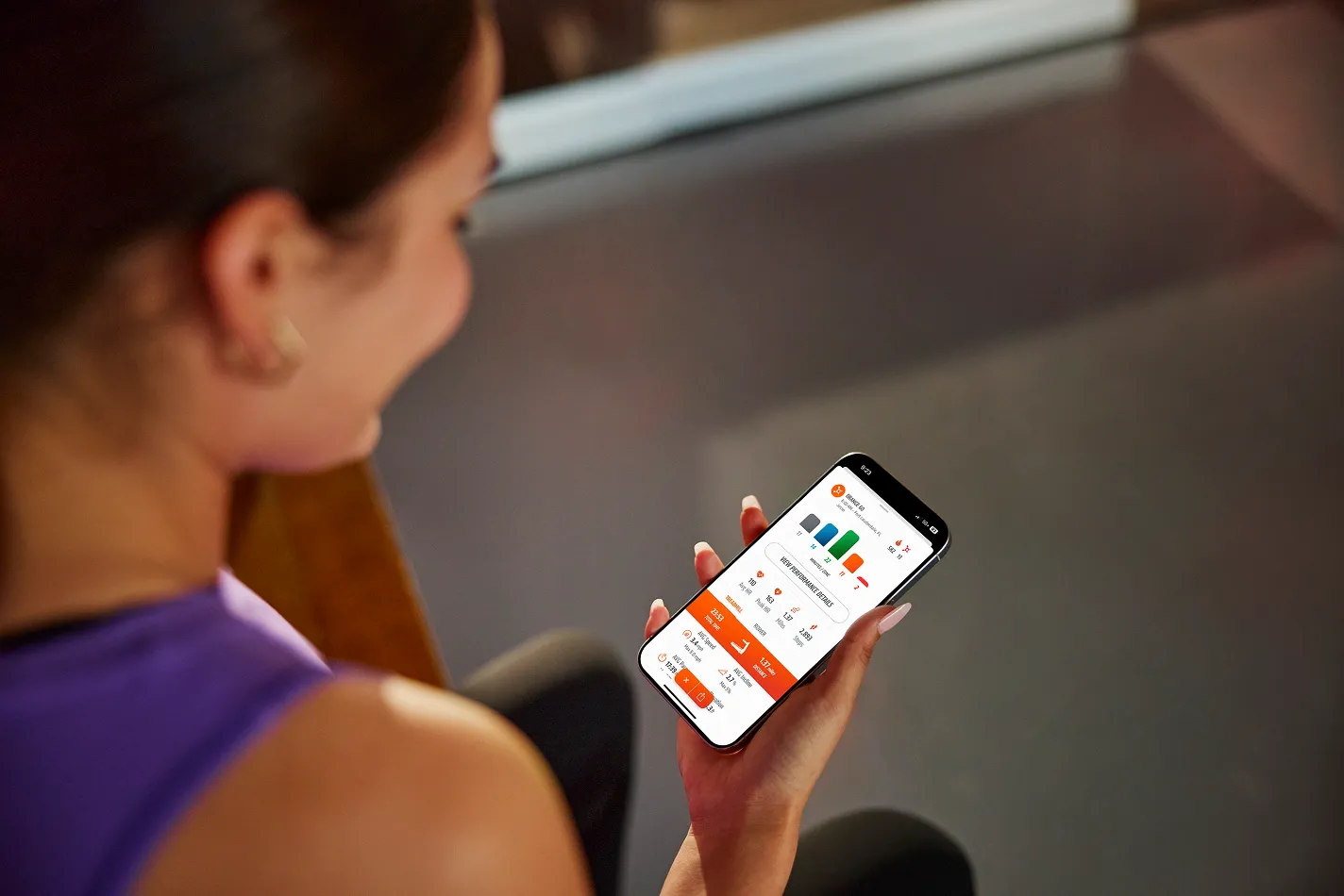 A close-up of a person using the Orangetheory mobile app on a smartphone.