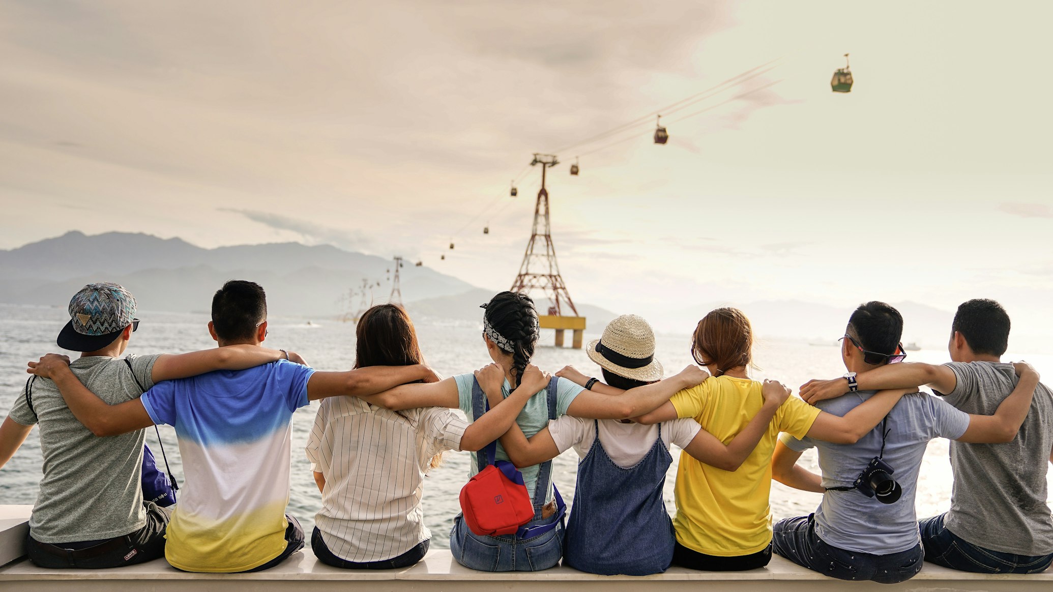 A diverse group of friends walking together outdoors, laughing and engaging in conversation.
