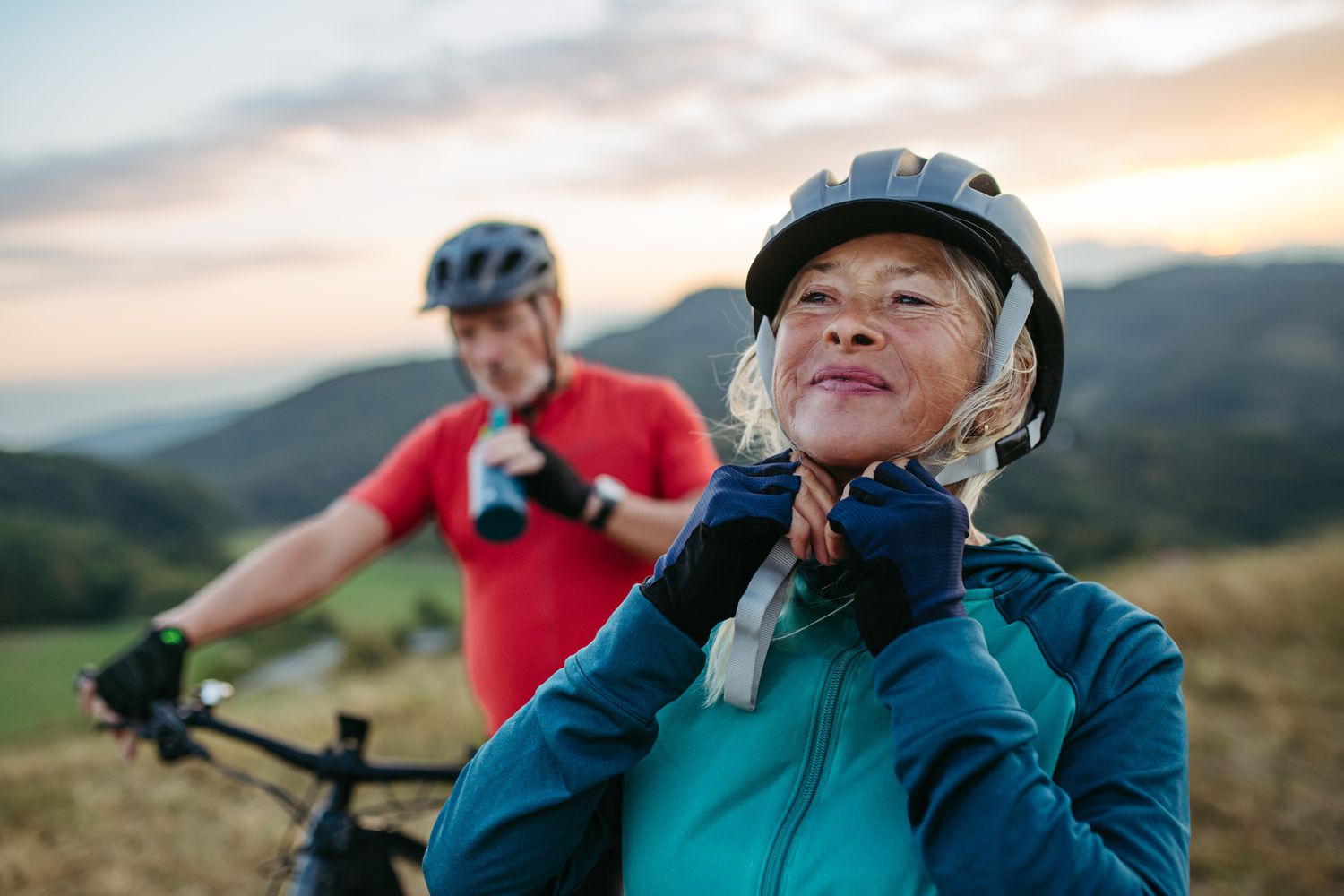 An older woman enjoying a bicycle ride, representing a return to functional mobility after sciatica recovery.