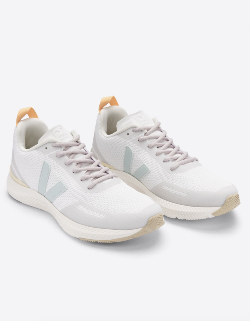 A pair of classic white leather tennis sneakers with a minimalist design.