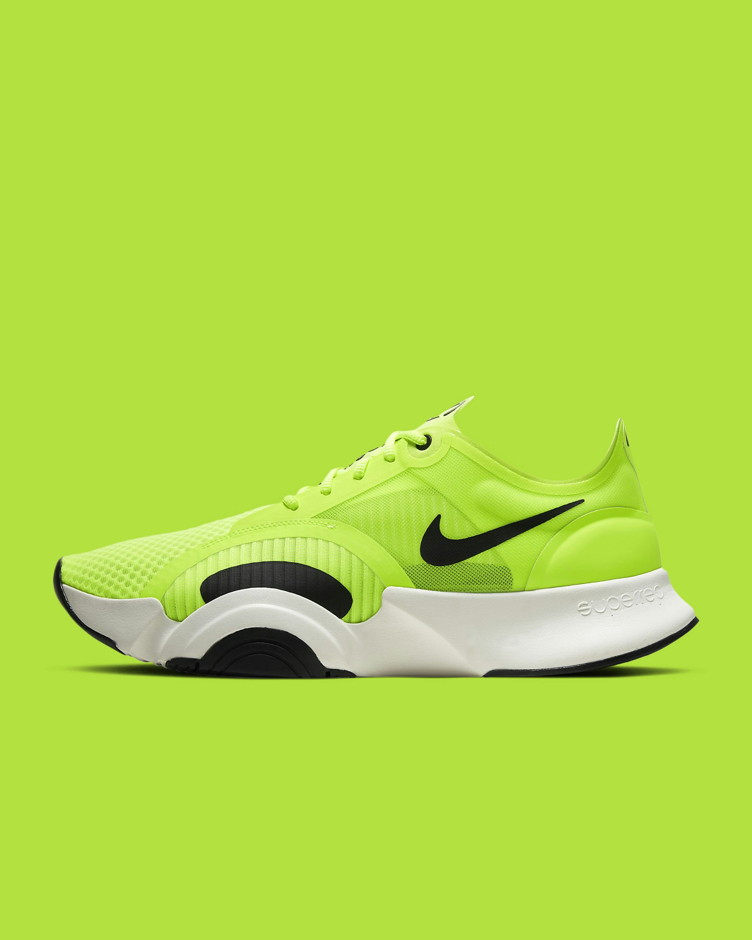 Close-up of lime green performance shoe upper showing the breathable mesh texture.
