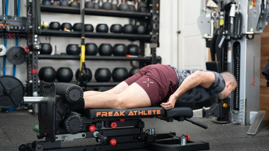 An athlete using the Freak Athlete Hyper Pro for leg extensions.