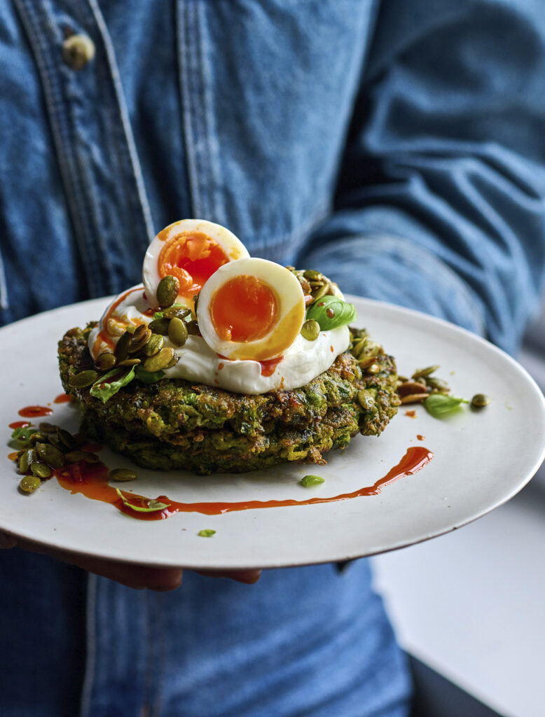 A stack of vibrant green savoury pancakes made with peas and cottage cheese.