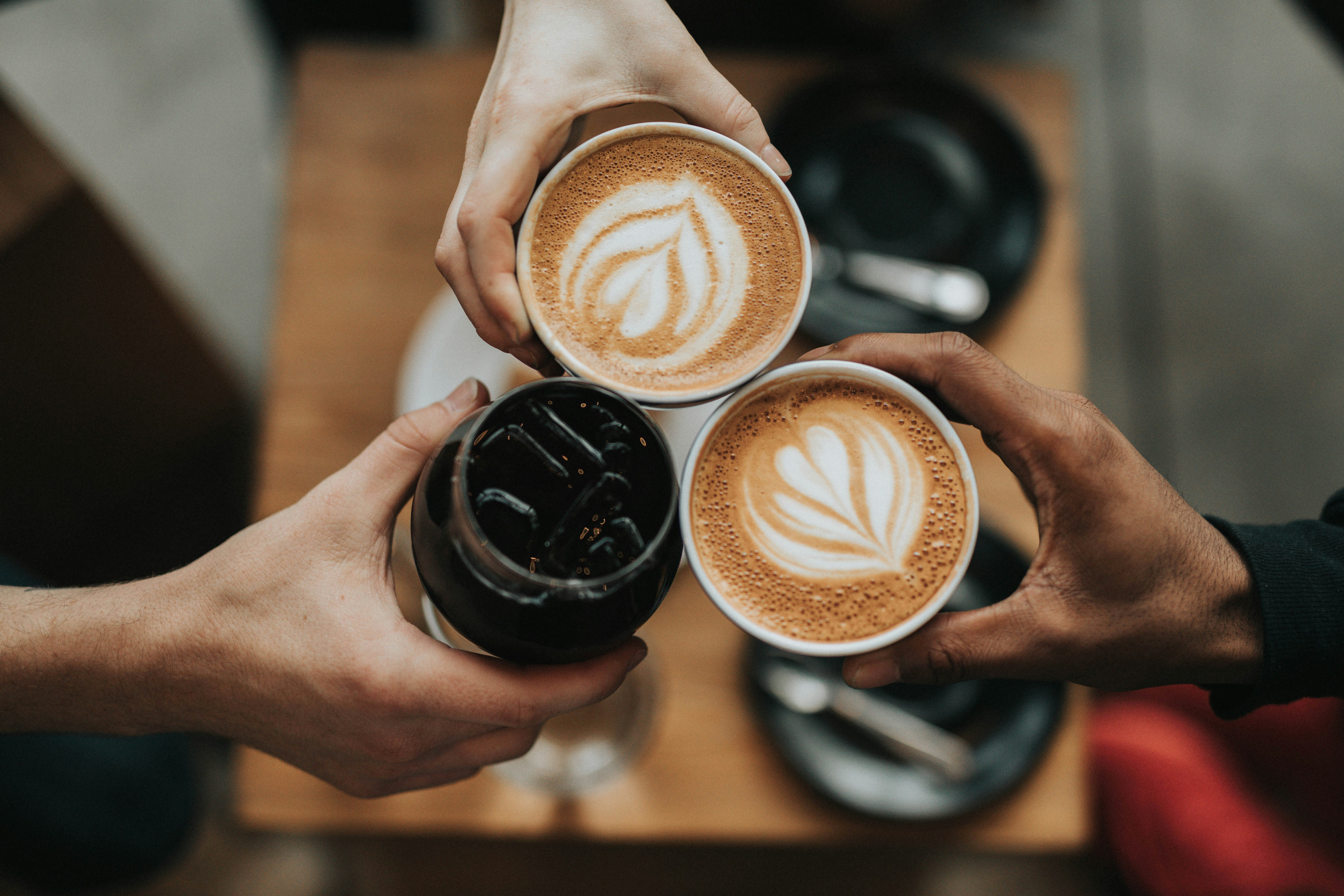 A close-up of a cup of coffee on a table, representing caffeine intake.