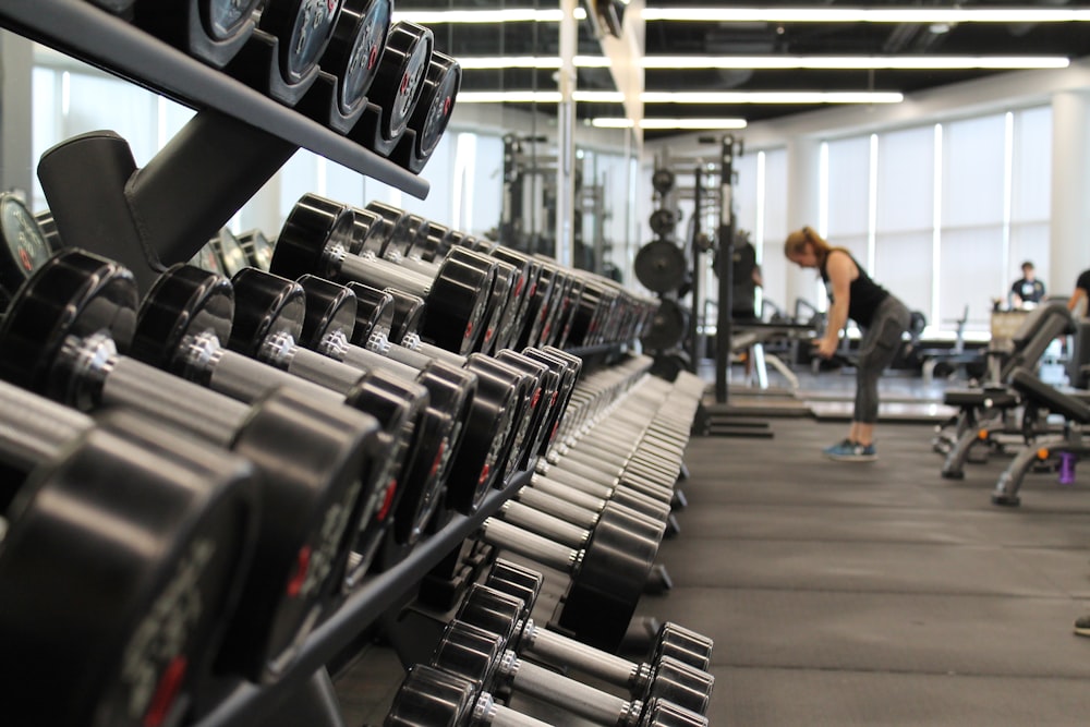 A person lying on a flat bench performing a barbell bench press with focus on form.