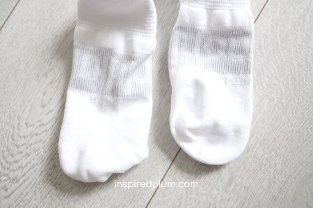 Detailed view of Lululemon socks showing specific 'L' and 'R' knitted markings for anatomical fit.