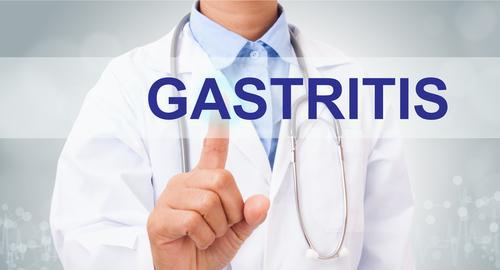 A patient holding their stomach due to inflammation symptoms.