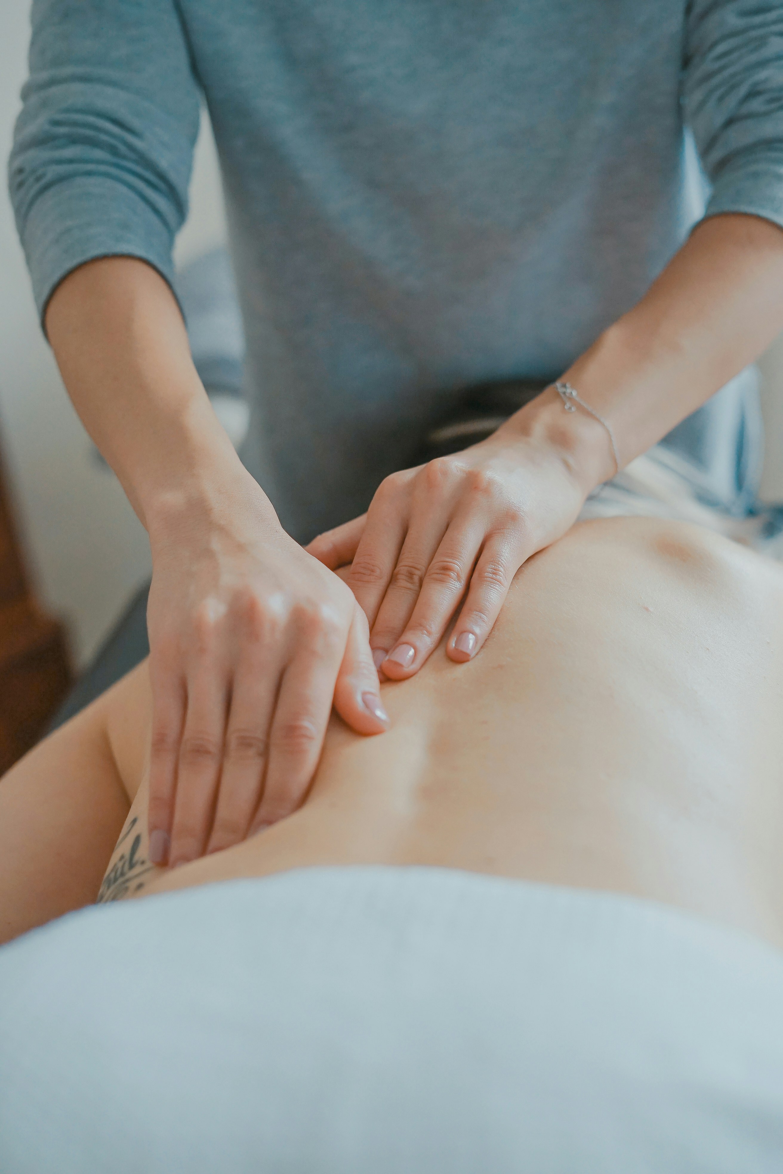 Close-up view of hands applying pressure and massaging a calf muscle.