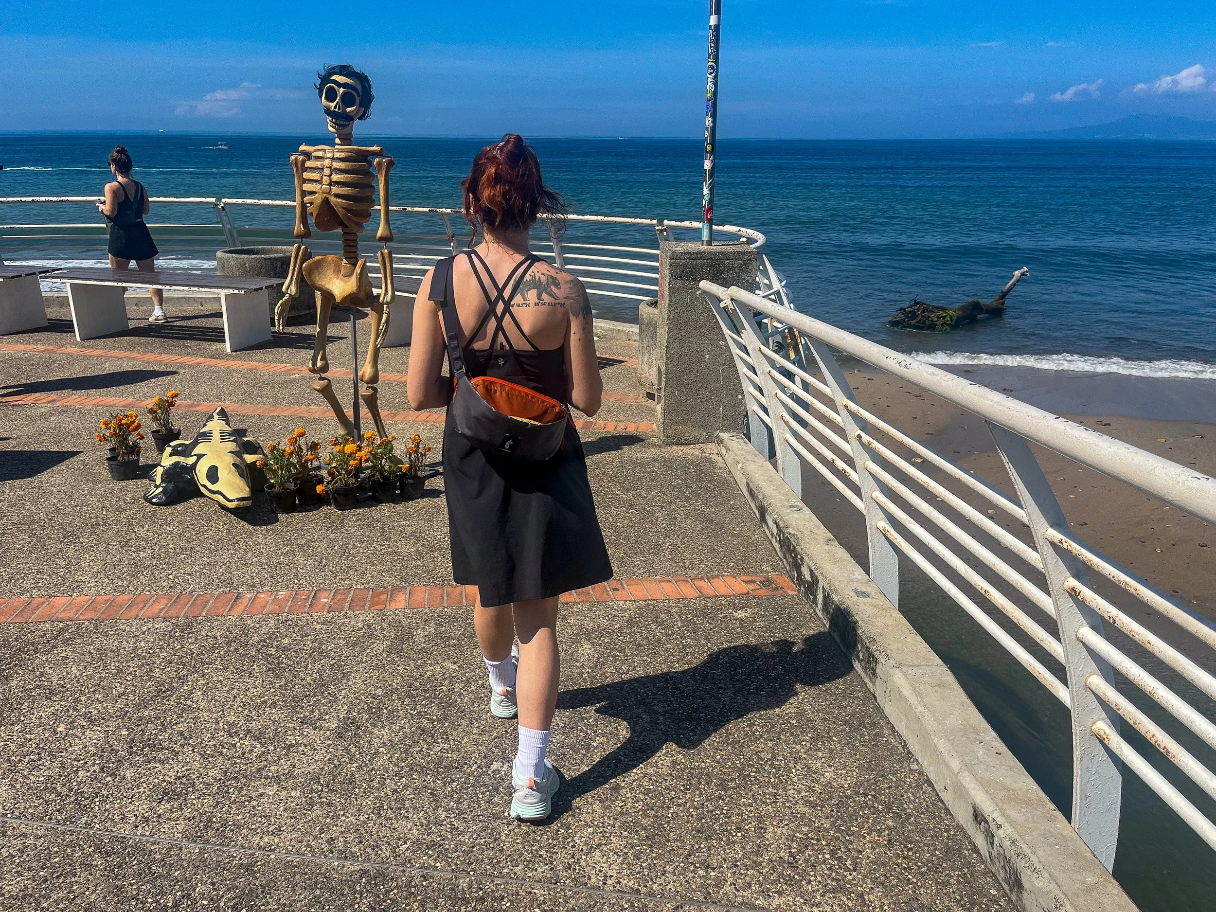 A person walking on a flat wooden pier wearing high-cushion HOKA shoes.