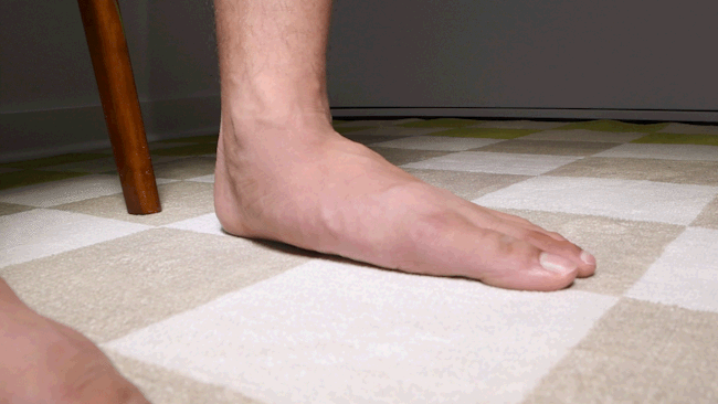 Close-up of a foot performing a foot doming exercise to raise the arch.
