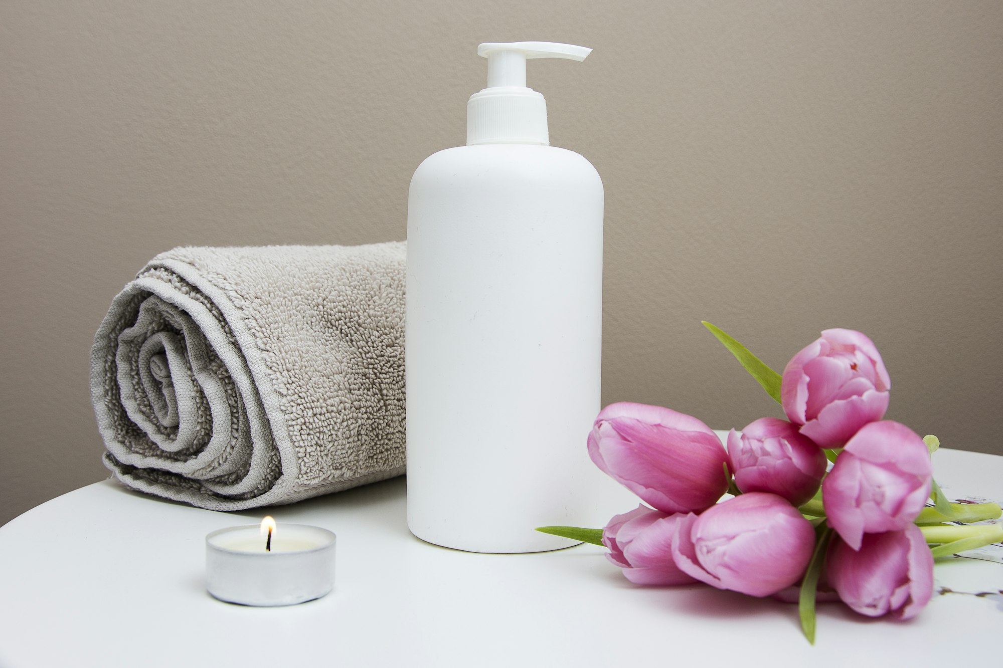 A steaming hot bathtub with candles, symbolizing a relaxation ritual before bed.