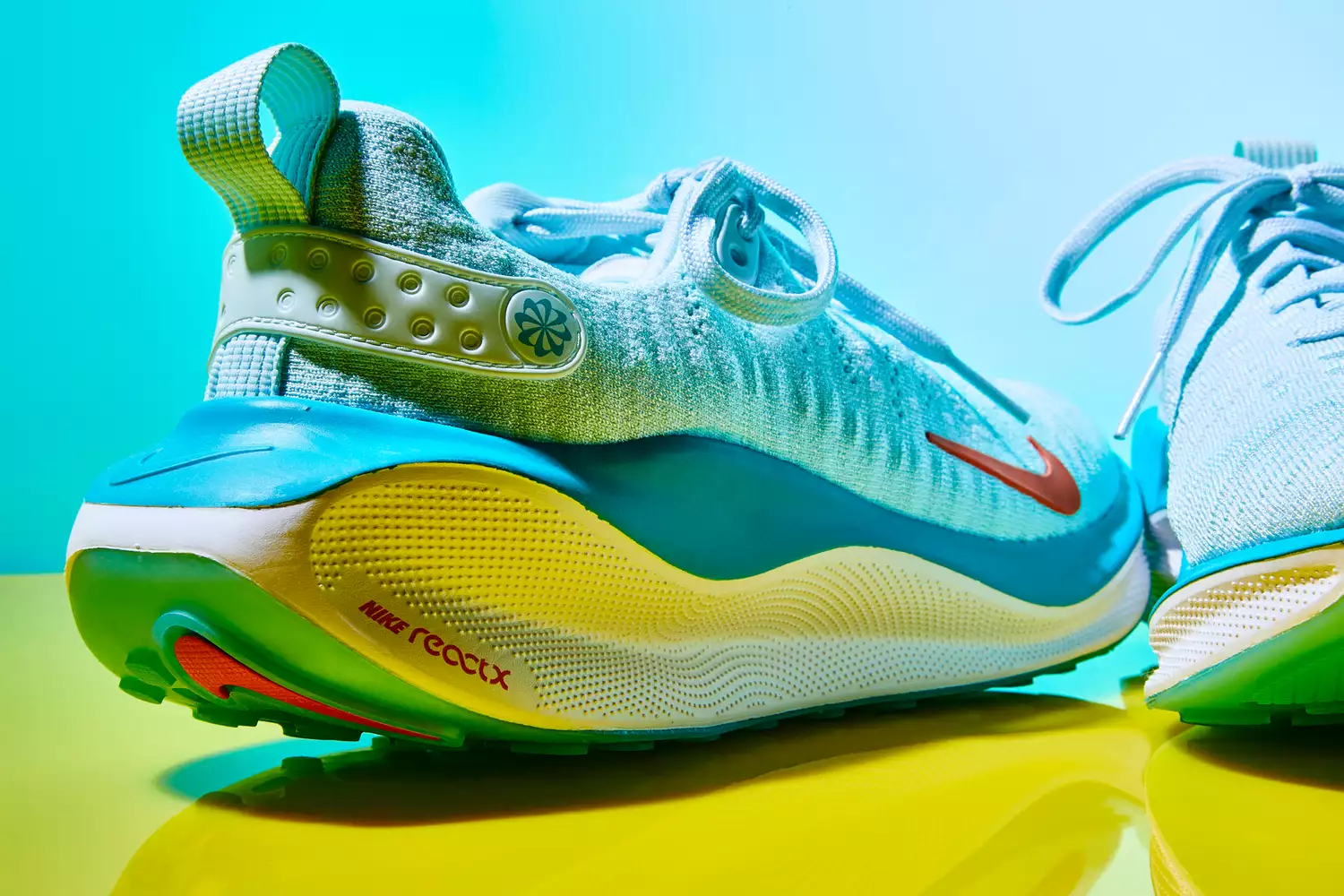 Close-up of a colorful Nike React running shoe showing the textured knit upper and layered sole.