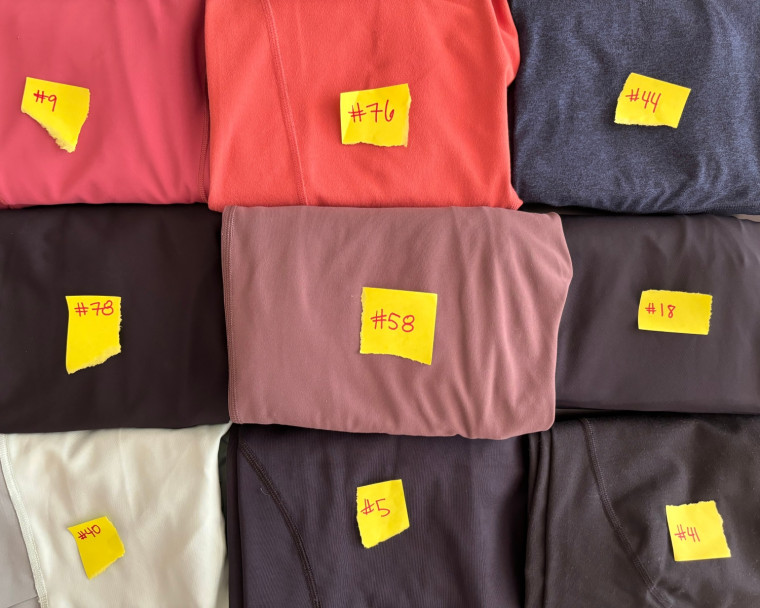 Close-up of a pair of leggings with a small white tag displaying a testing identification number.