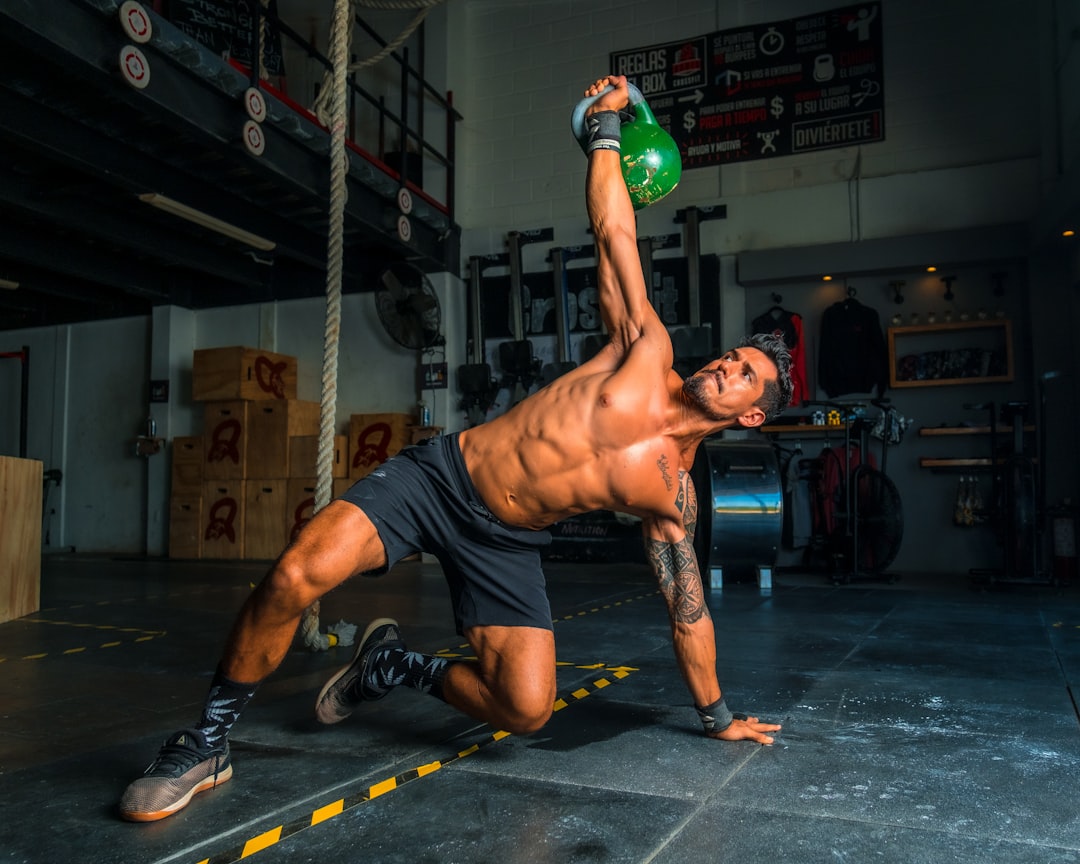 A fitness enthusiast performing mountain climbers on the floor for core and cardio intensity.