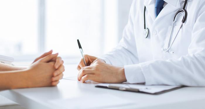 A healthcare professional discussing heart health with a patient in a clinical setting.