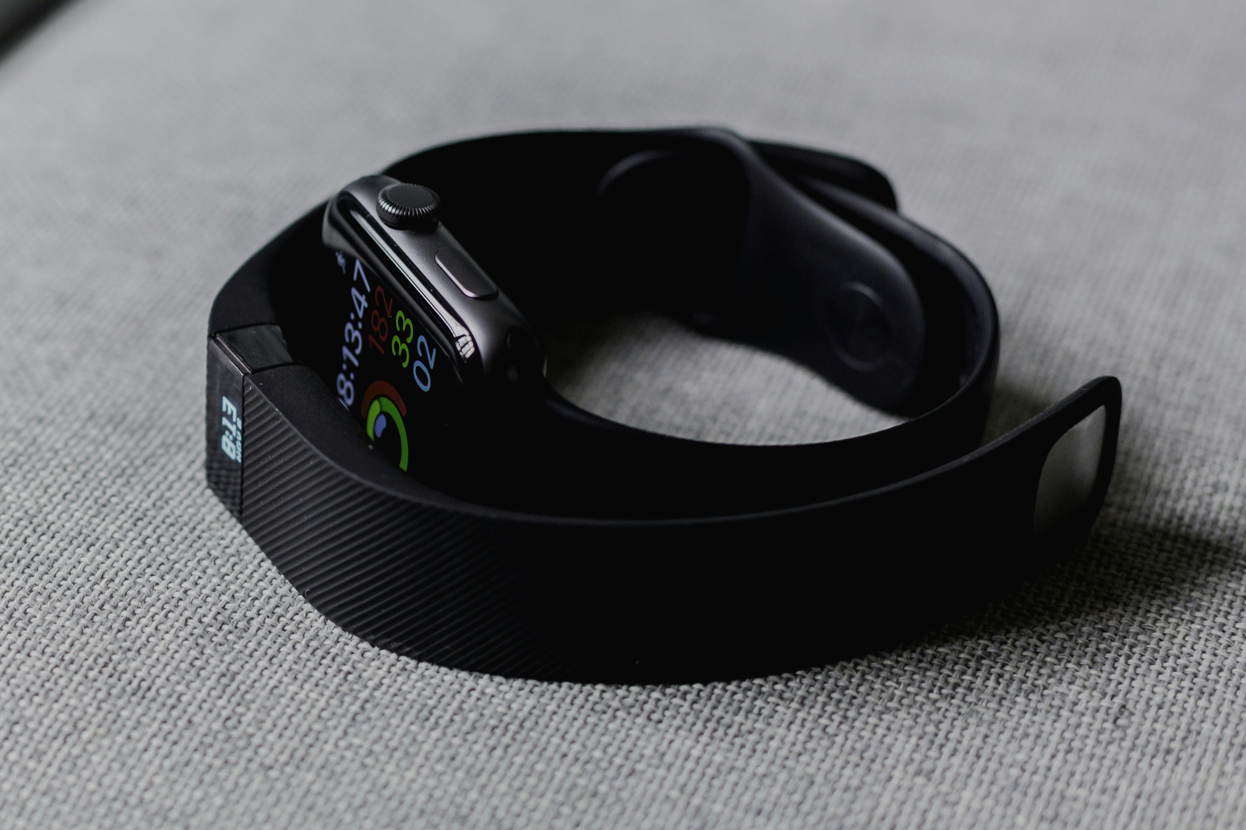Close up of a modern smartwatch on a wrist showing a heart rate reading.