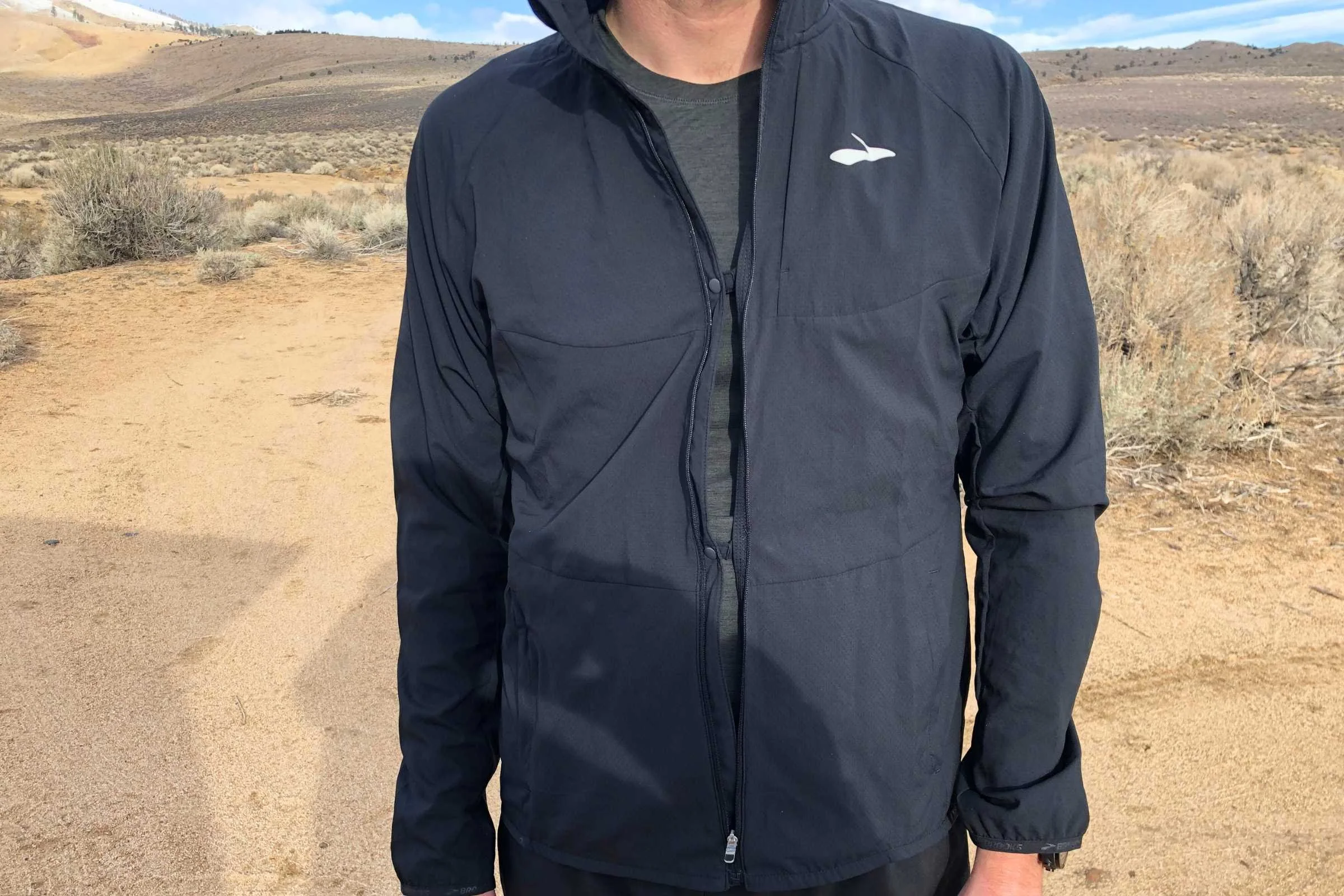Close-up view of ventilation button snaps on a performance running jacket.