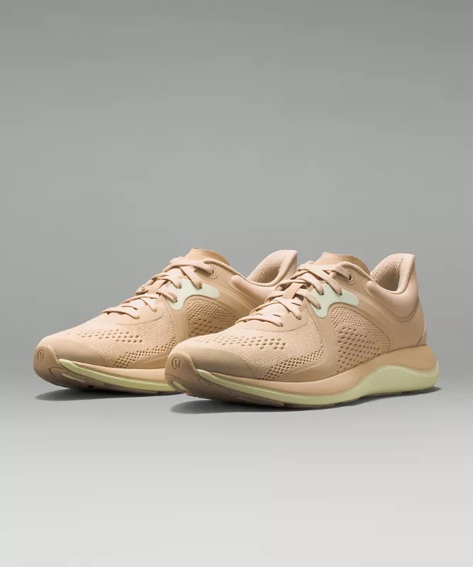 A white Lululemon Chargefeel Low workout shoe designed for cross-training.