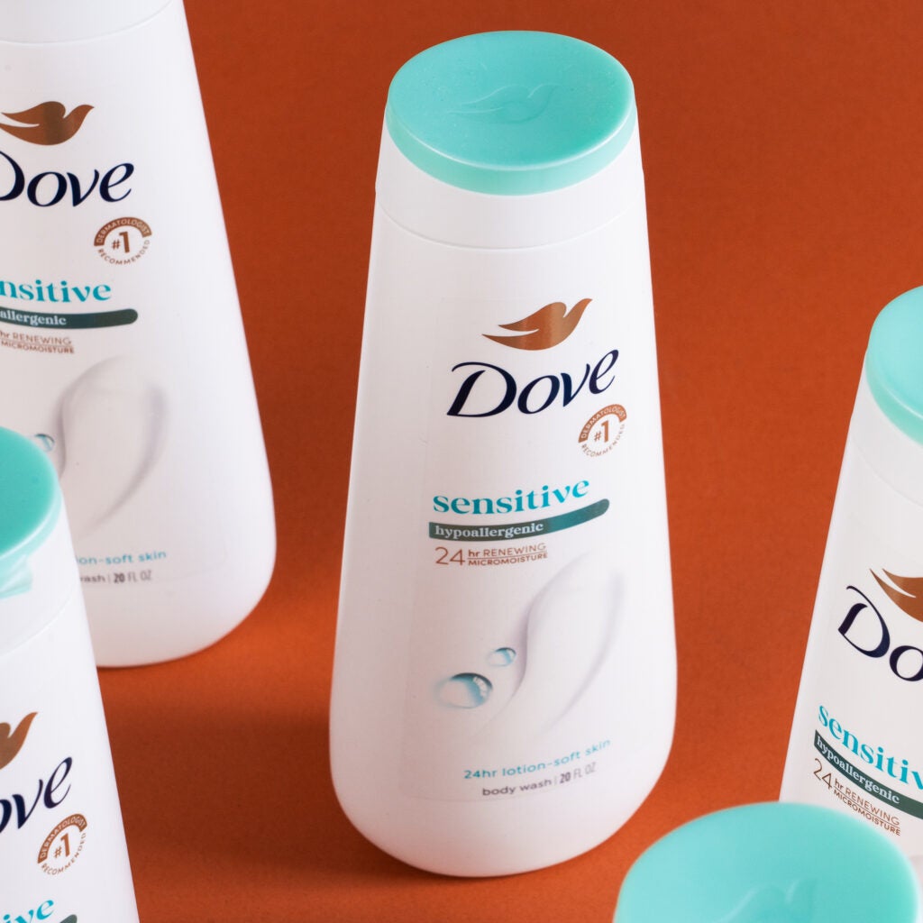 Close-up of multiple Dove Sensitive Body Wash bottles.