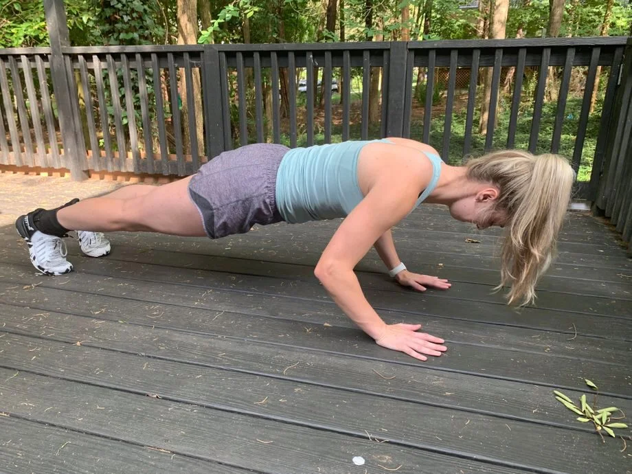 A person holding a plank position on a mat, highlighting bodyweight exercise form.
