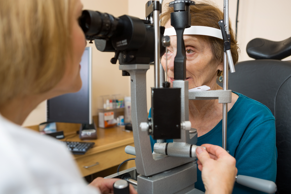 An elderly patient undergoing a professional eye examination in a clinical setting.