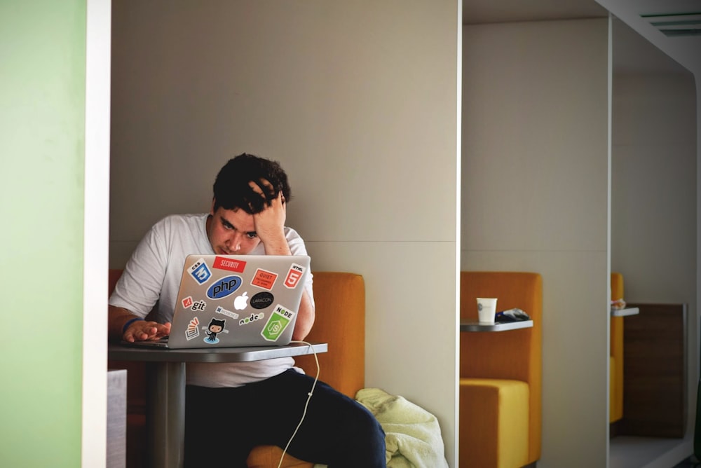 An exhausted person leaning their head on a desk, representing cognitive fatigue.