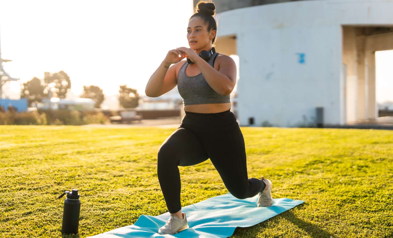 A person performing lunges on a yoga mat to maintain lower body strength.