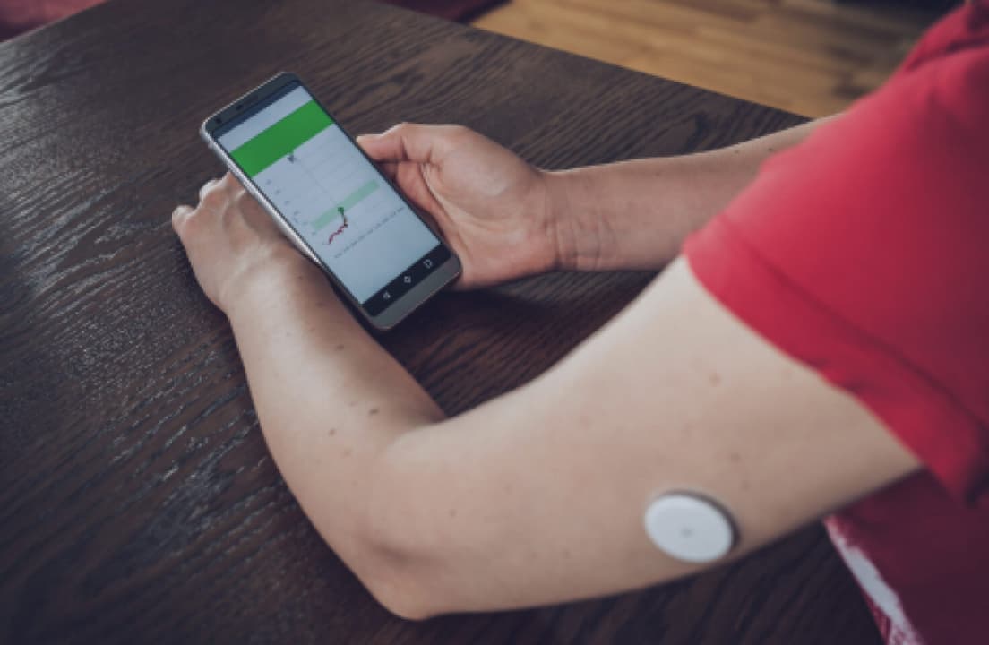 The Dexcom G7 sensor and its simplified applicator tool on a plain background.