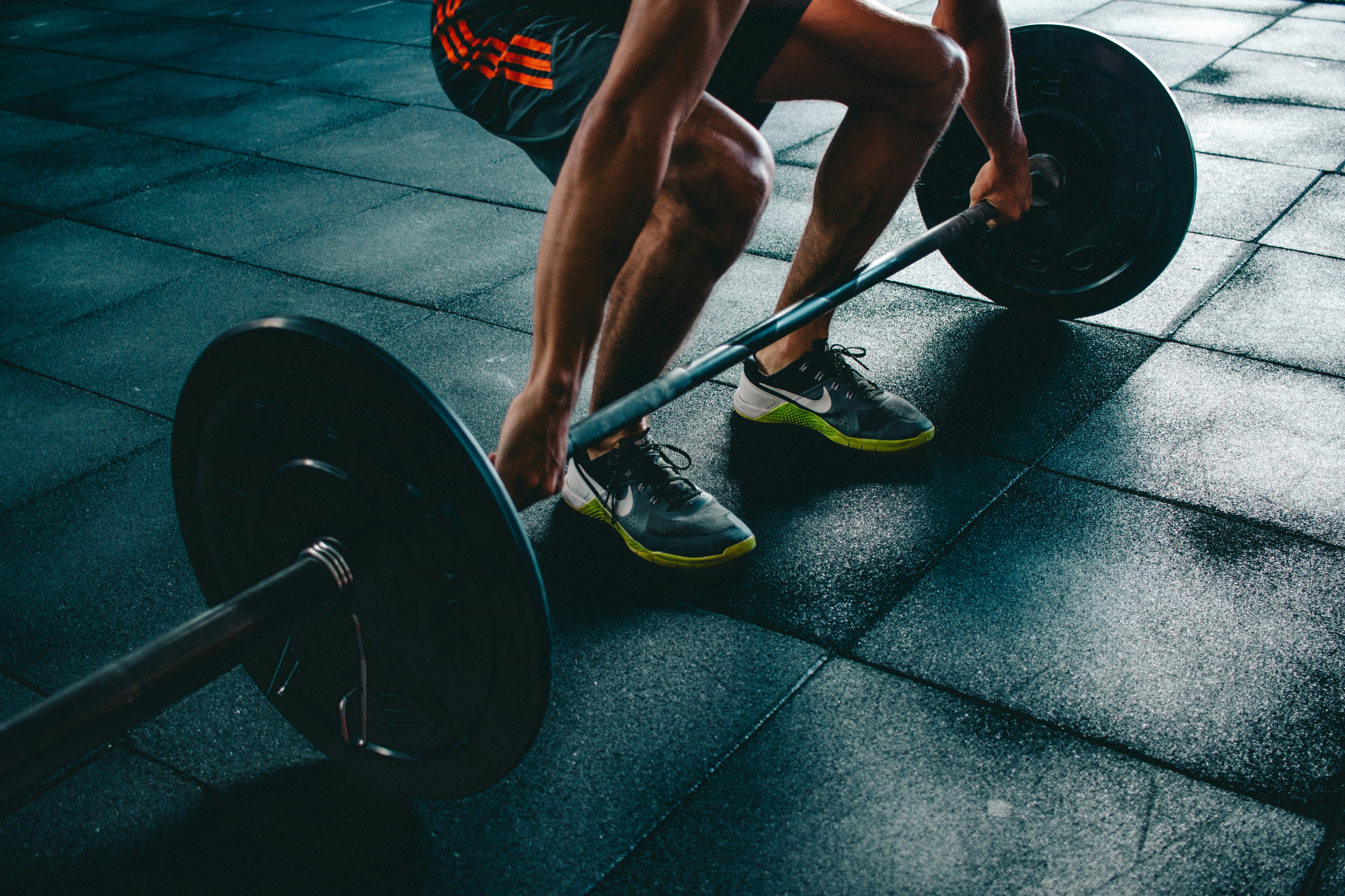 An athlete wearing breathable synthetic performance fabrics while performing a HIIT circuit.