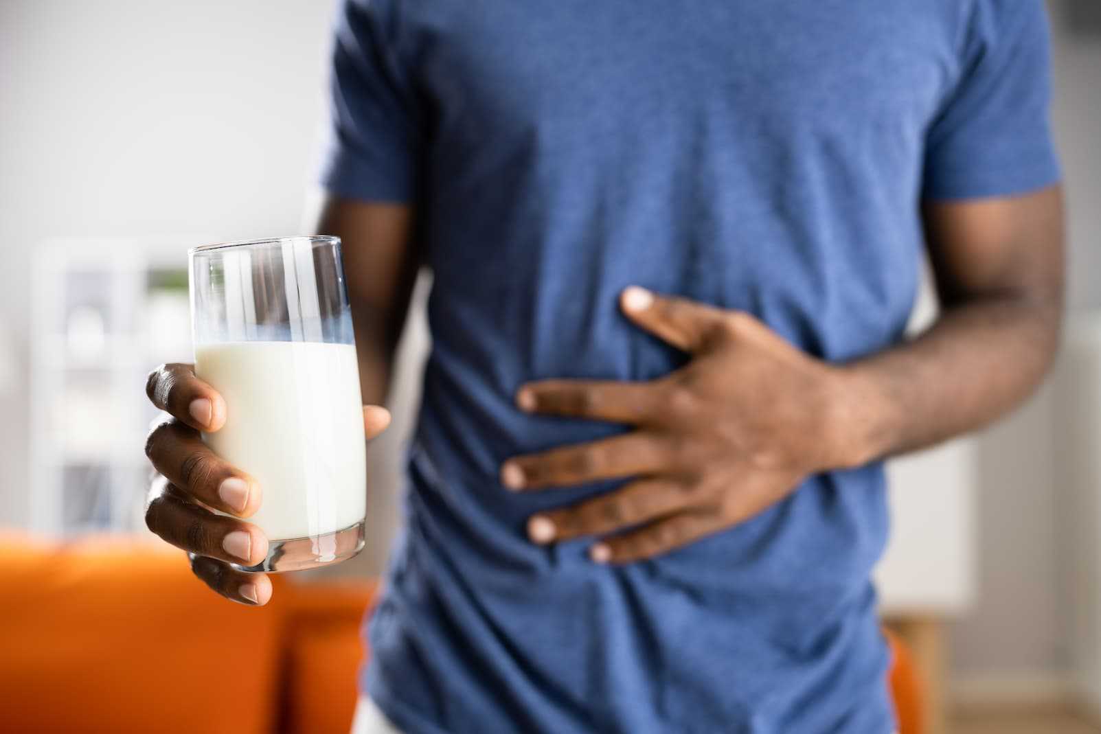 A glass of fresh milk on a table, symbolizing a common food allergen.