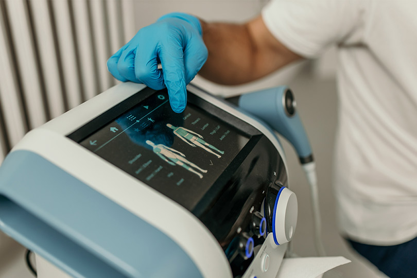 A medical professional operating a high-tech scanning machine for precision pain diagnosis.