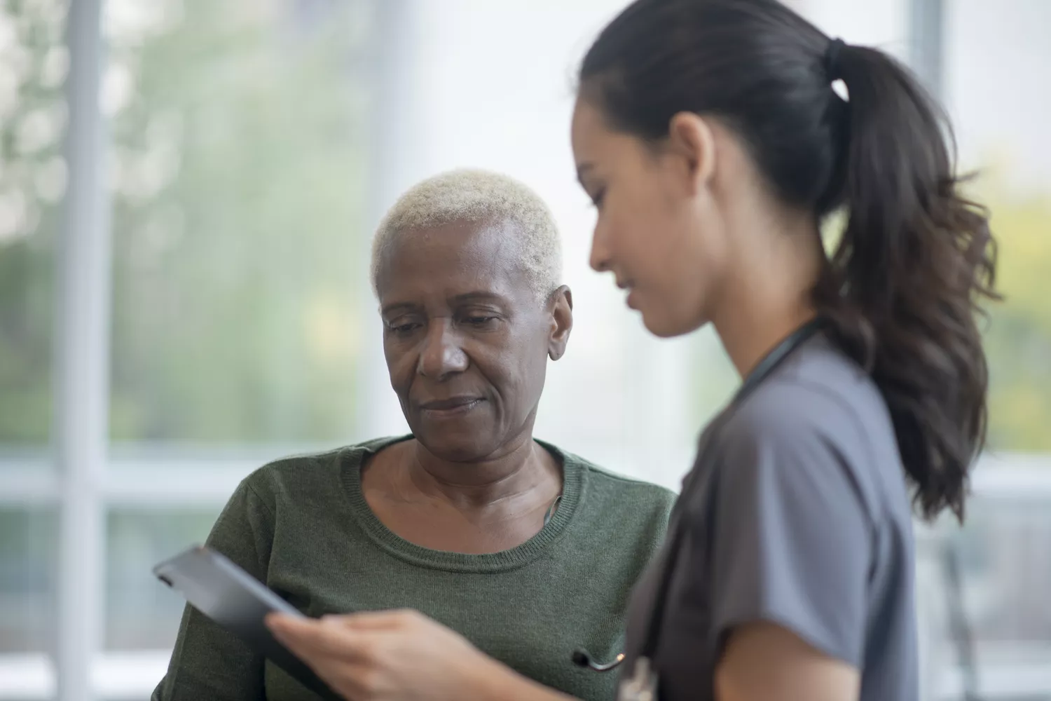A patient and a doctor discussing the link between diabetes and chronic kidney disease in a clinical setting.