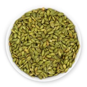 A close-up view of a ceramic bowl overflowing with nutrient-dense pumpkin seeds.