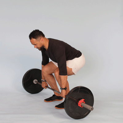 An athlete performing the first pull of a power clean, lifting the bar from the floor to knee level.