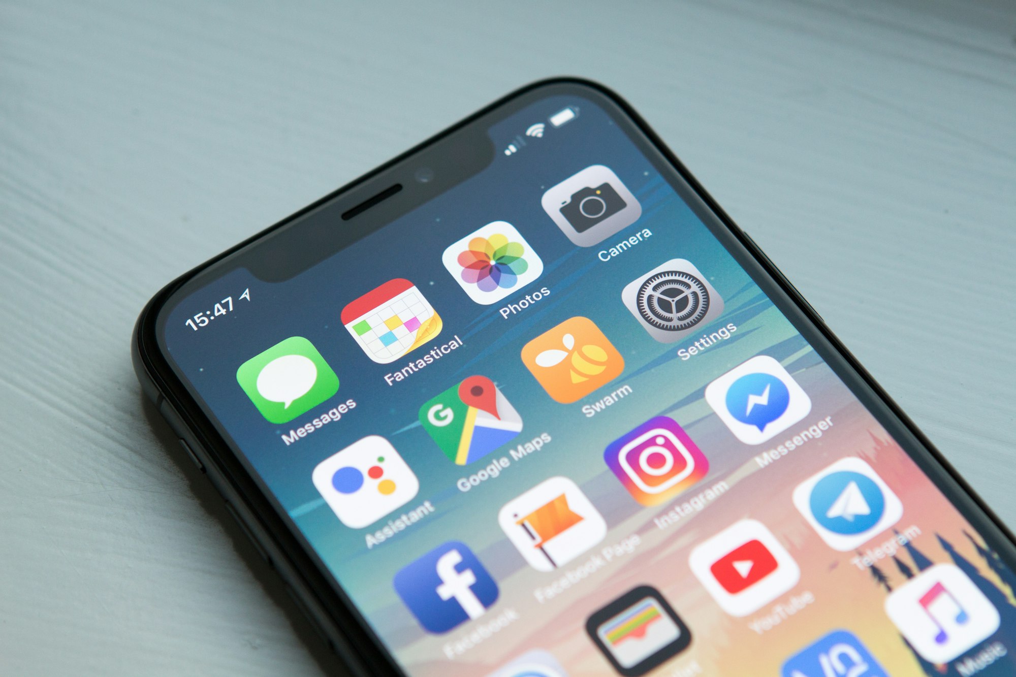 Smartphone with multiple notification bubbles representing digital exhaustion.