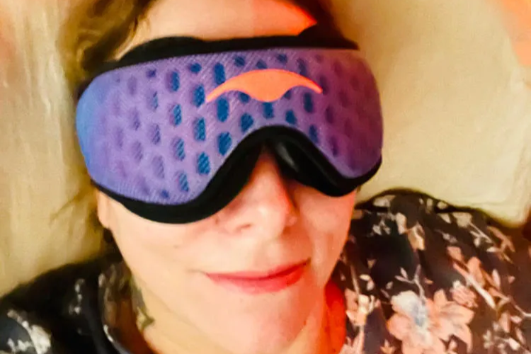 A woman wearing a breathable mesh sleep mask looking relaxed.