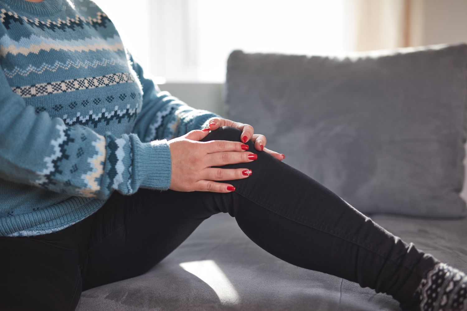 An older person sitting on a sofa, representing the senior demographic discussed in the mobility section.