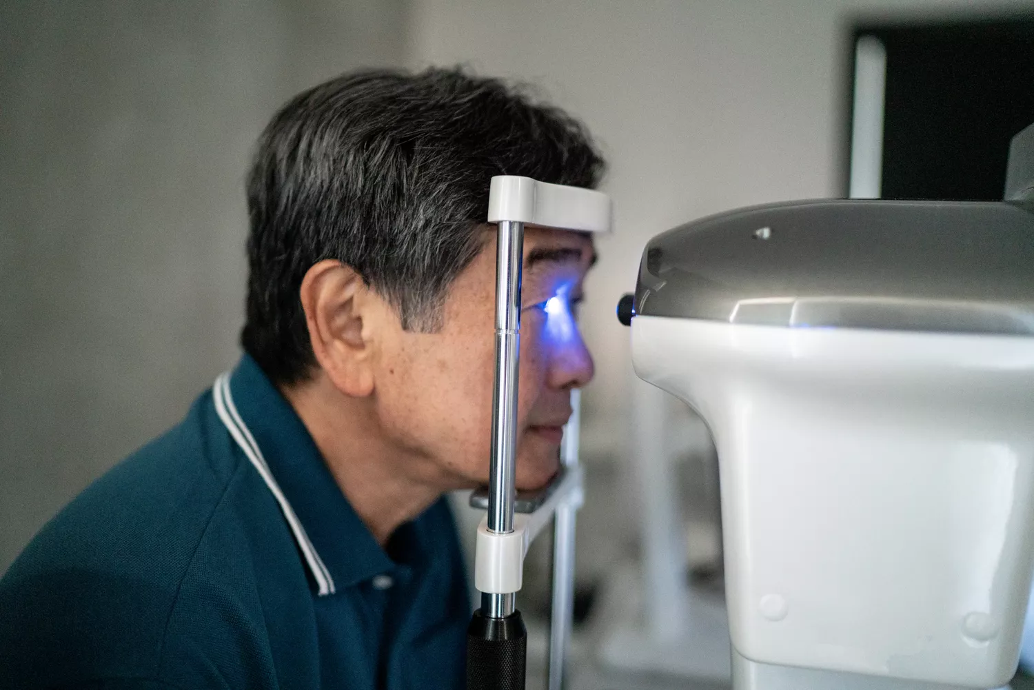 A patient receiving a medical examination from a healthcare professional in a clinic.