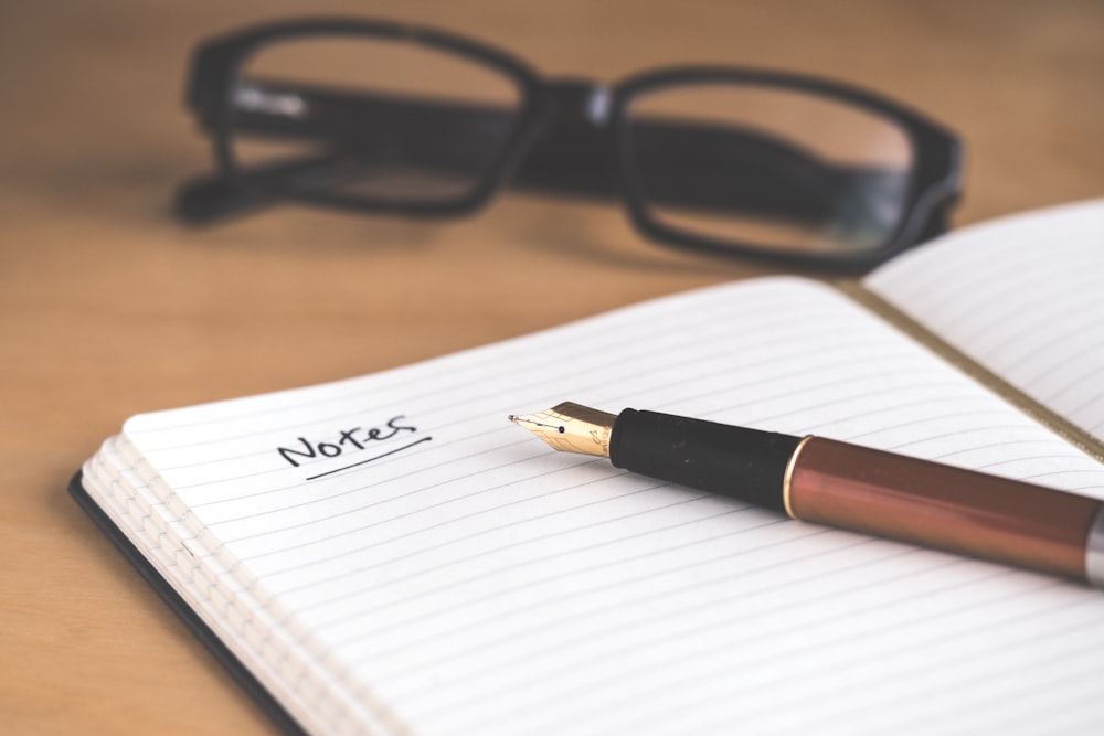 A health diary and pen used for manual symptom and activity tracking.