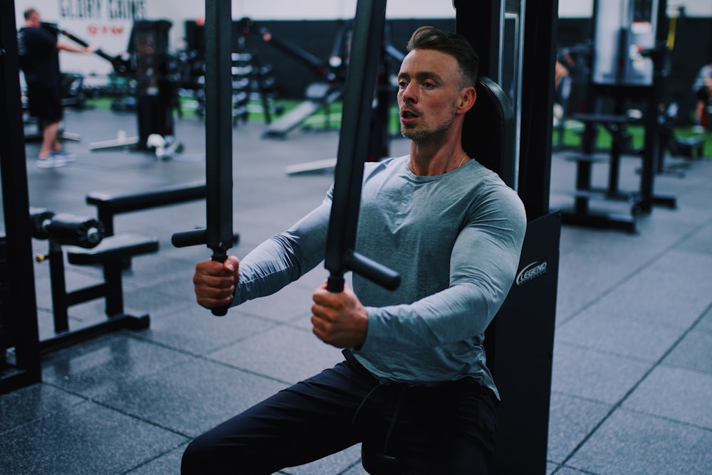 An athlete performing dumbbell lateral raises to isolate the shoulder muscles.