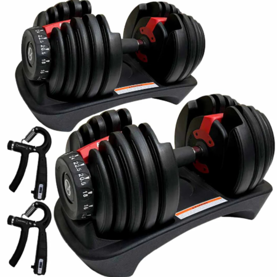 A pair of compact adjustable dumbbells stored neatly in their respective cradles on the floor.