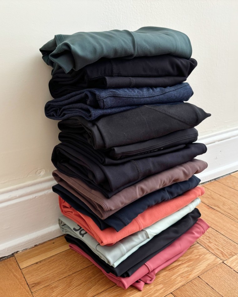 A variety of colorful leggings hanging neatly on a professional clothing rack for review.