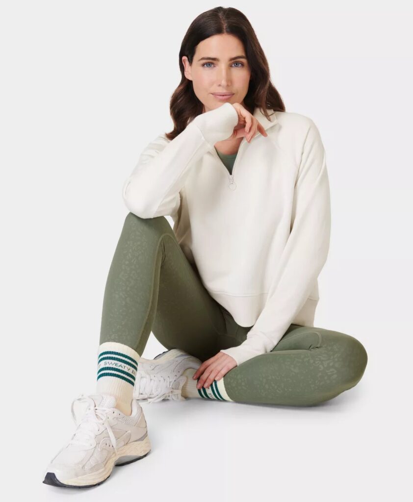 A pair of khaki-colored Sweaty Betty compression leggings with a textured finish.