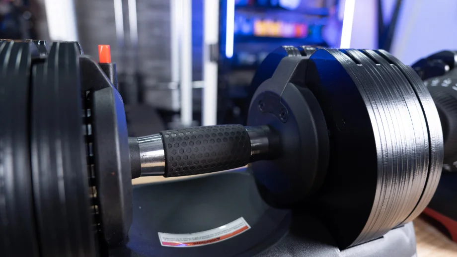 Detailed view of an Ativafit adjustable dumbbell handle highlighting the grip texture.